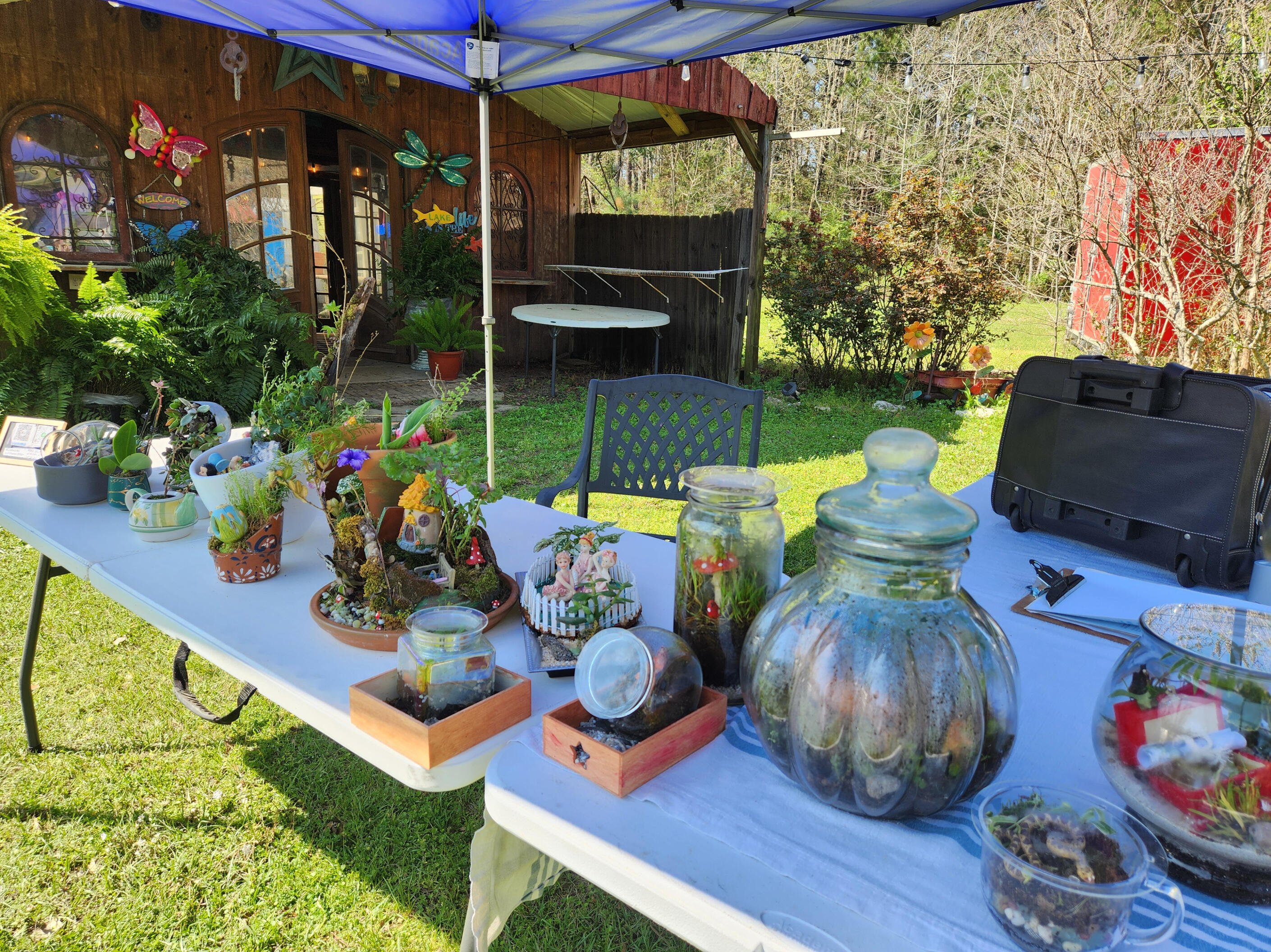 Table set up for market event by Sharm's Green Thumb plant nursery logo - Longview TX
